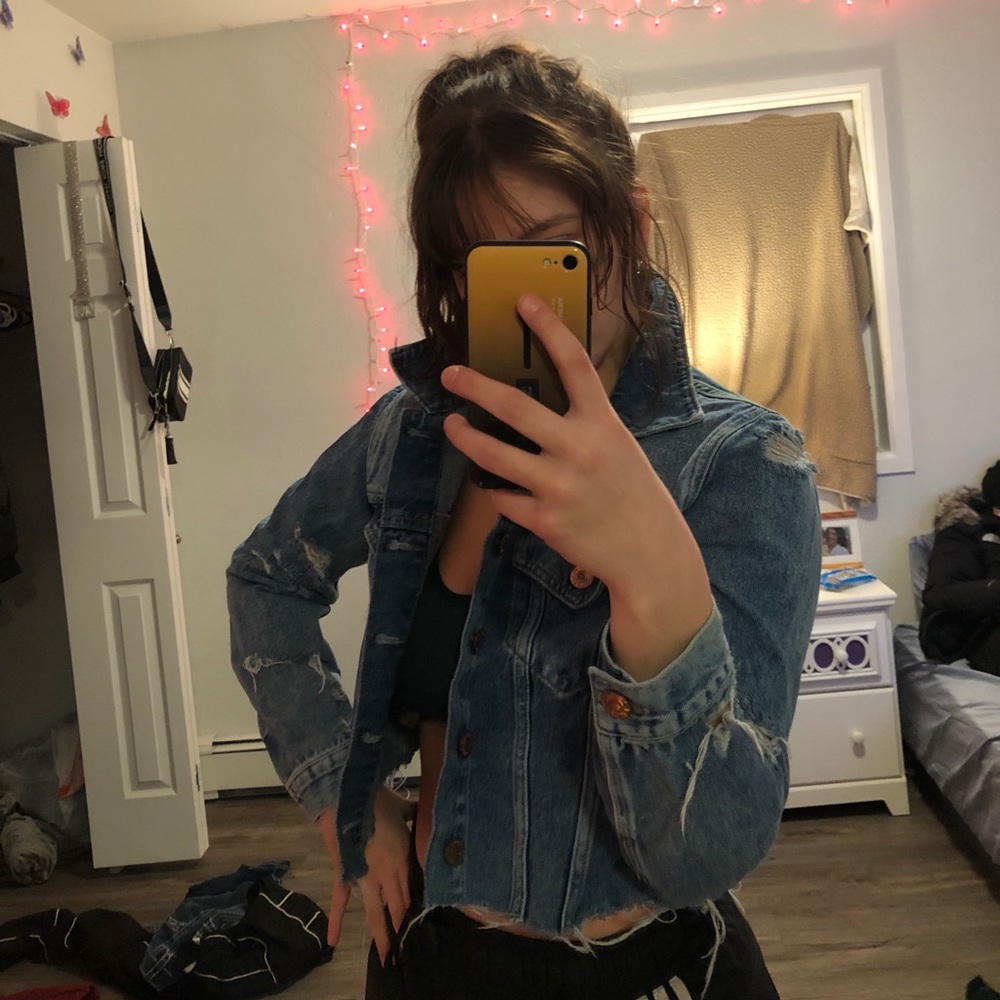 Distressed cropped denim jacket.